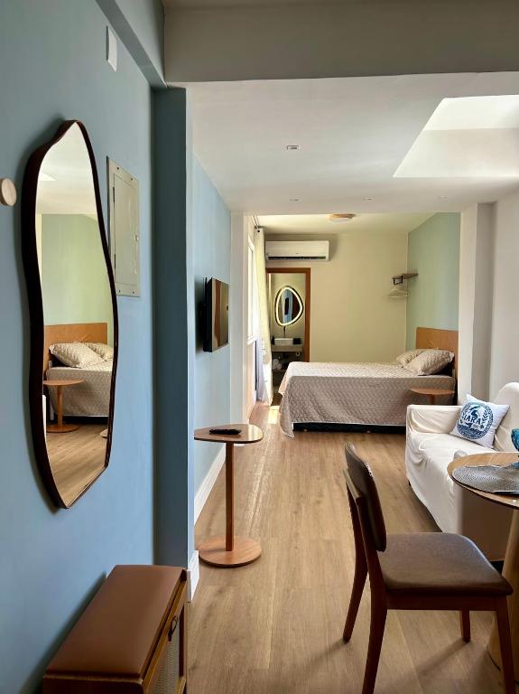 a room with two beds and a mirror at Iara & Muira Apartments in Belém