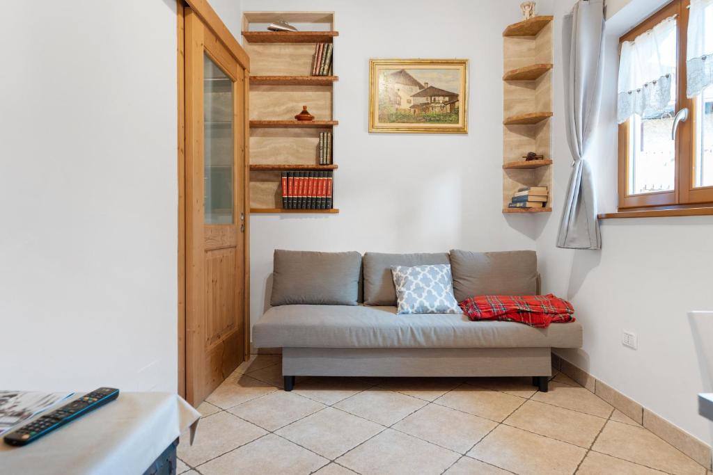 a living room with a couch in a room at Apartment Goldener Schnee Tesero in Tesero