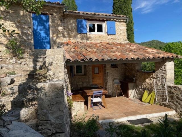 a house with a wooden deck in front of it at Les Eyssaux en Baronnies Provençales in Reilhanette