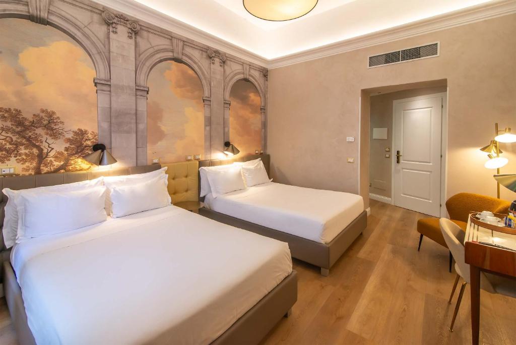 Ένα ή περισσότερα κρεβάτια σε δωμάτιο στο Hotel Accademia