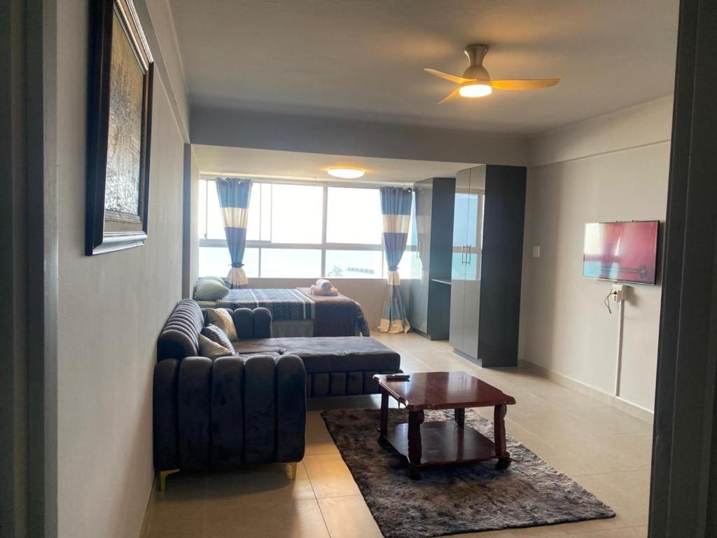 a living room with a couch and a bed at Akwabahouse in Durban