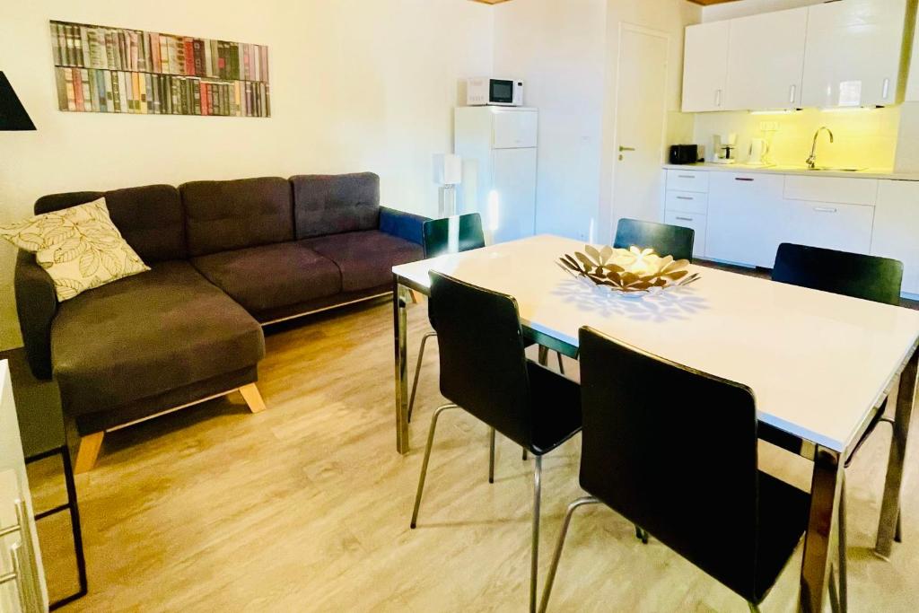 a kitchen and living room with a table and a couch at Cozy Apartment next to the Slopes Sleeps 4 in Vars