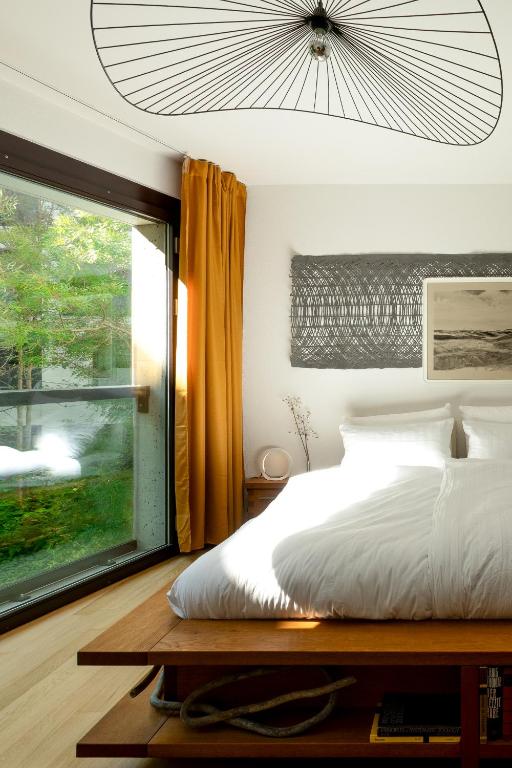 a bedroom with a white bed and a window at Urban Design Loft - Basel - Free Parking in Basel