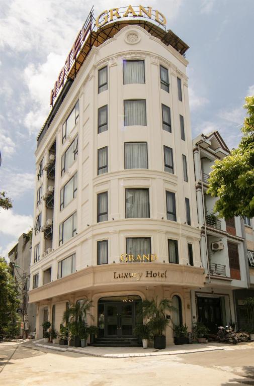 a large white building with a sign on it at Grand Hotel Vinh Yen in Vĩnh Phúc