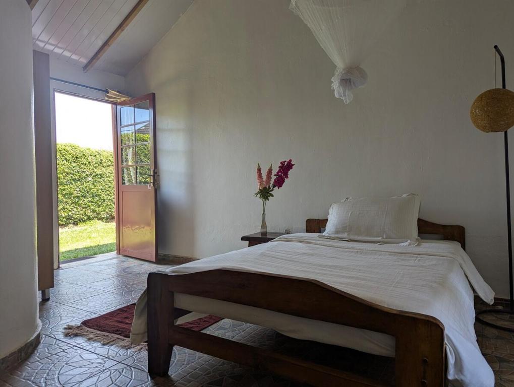 a bedroom with a large bed and a window at Private Rooms Ensuite Bathroom Garden Access in Kigali