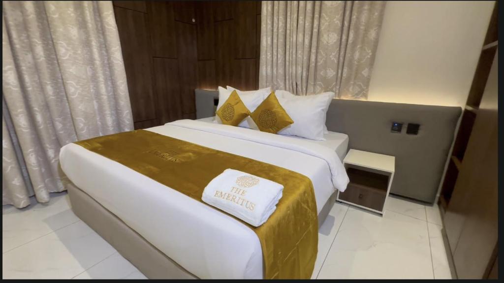 a hotel room with a large bed in a room at The Emeritus Apartments in Akure