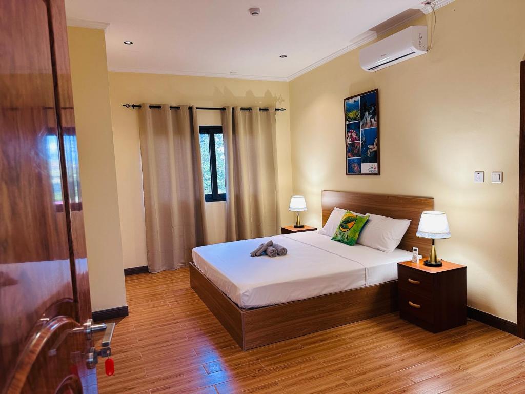 a bedroom with a bed with a stuffed animal on it at Sren Self Catering - One Bedroom II in Anse Royale