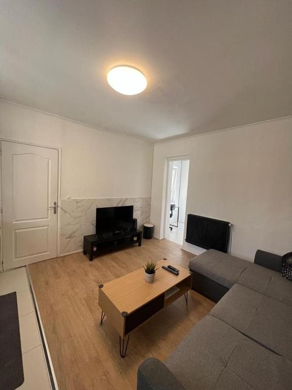 a living room with a couch and a coffee table at 2 bedroom Apartment very close to Paris in Bobigny