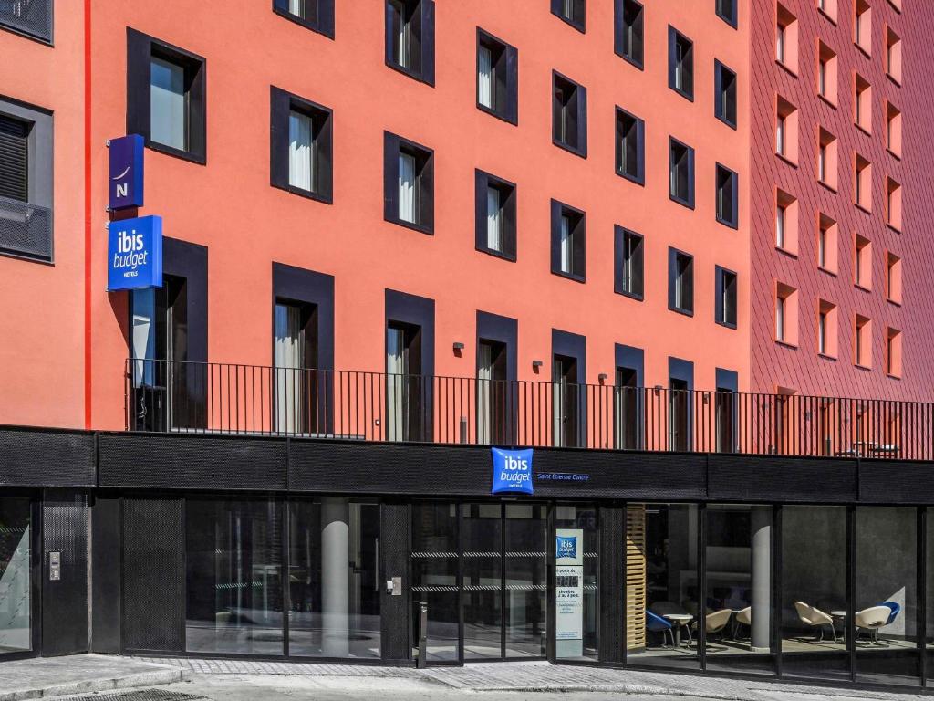 an orange building with a balcony in front of it at ibis budget Saint-Étienne Centre Gare Châteaucreux in Saint-Étienne