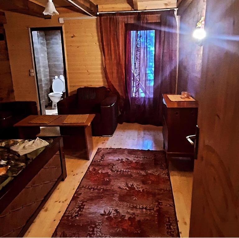 a living room with a couch and a table at Bakhmaro Lodge in Bakhmaro