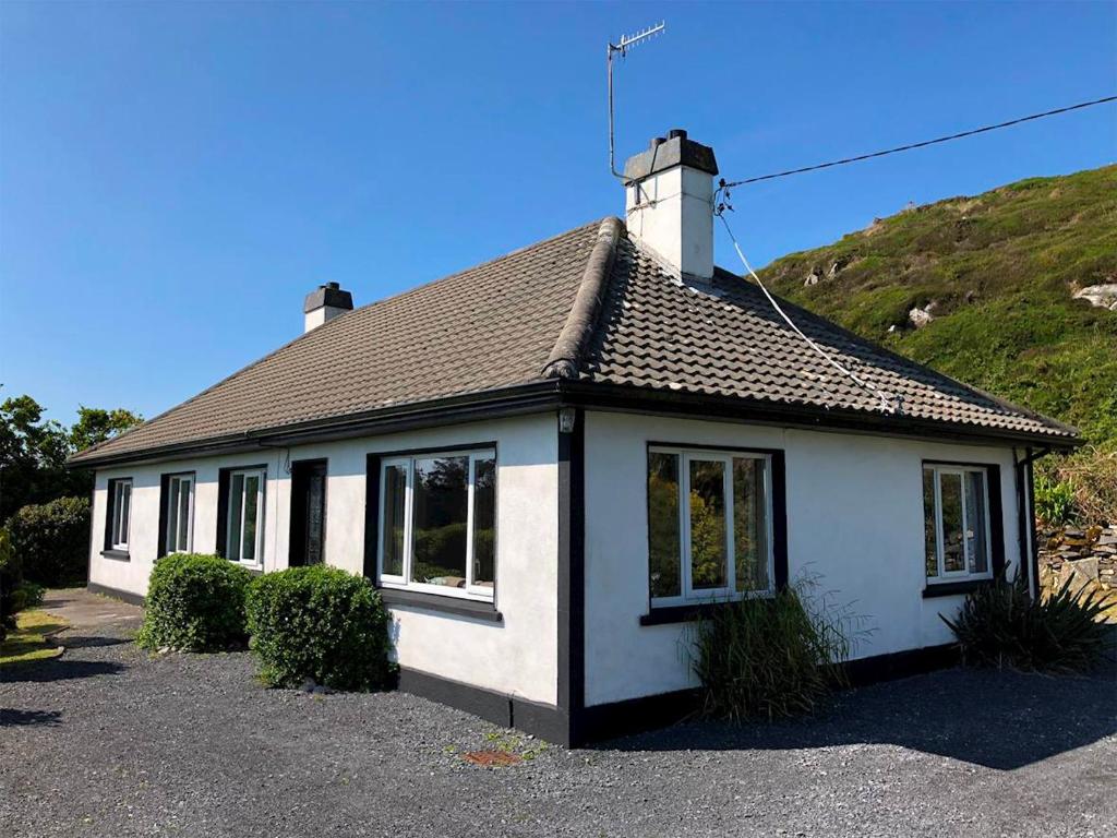 a white house with a chimney on top of it at 5 Bed in Clifden oc-ii05854 in Kill