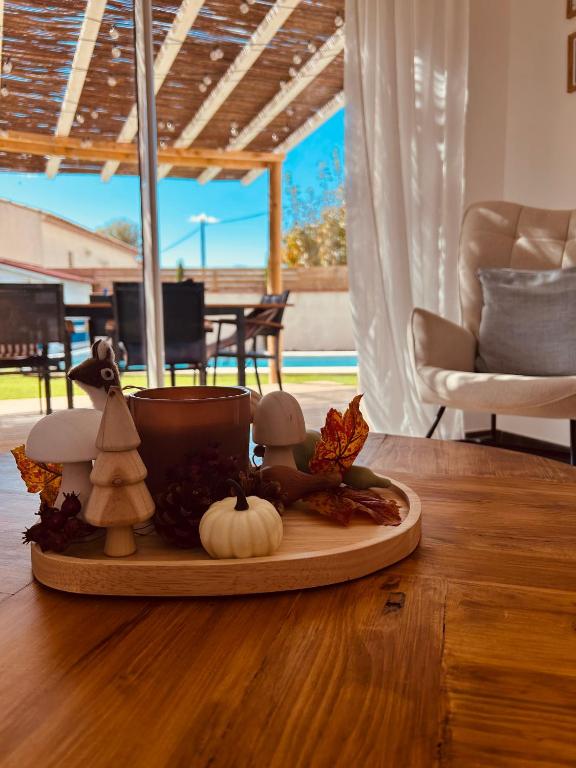 a tray with pumpkins and a candle on a table at Le Cottage de Felix in Canet d'Aude