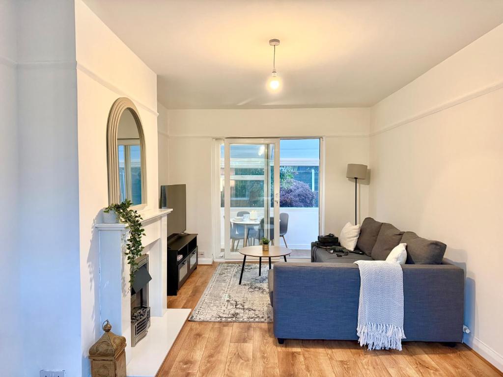 a living room with a couch and a fireplace at Stockport Stays in Stockport