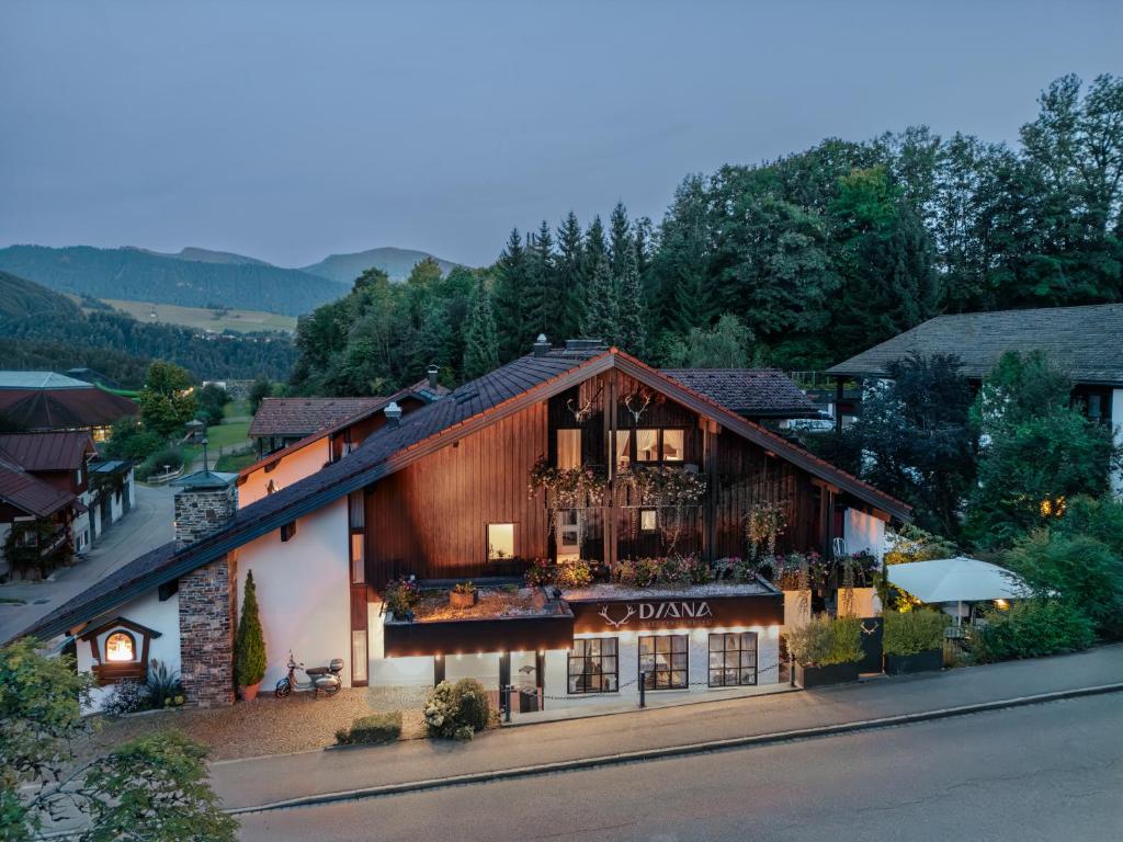 a building with a balcony with flowers on it at DIANA Naturpark Hotel - Partnerbetrieb von "Oberstaufen PLUS GOLF" in Oberstaufen