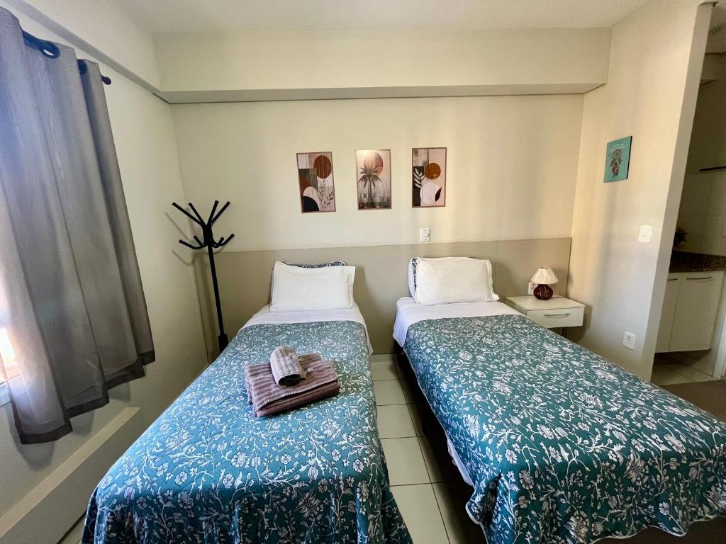 En eller flere senge i et værelse på Studio Iguatemi Ribeirão Preto