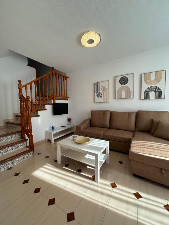 a living room with a couch and a table at Casa familiar in Torrevieja