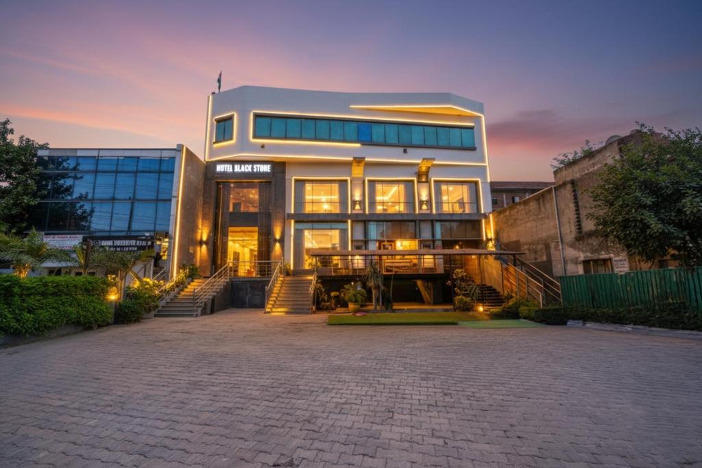 a large building with stairs leading up to it at FabHotel Black Stone Palace in Ghaziabad