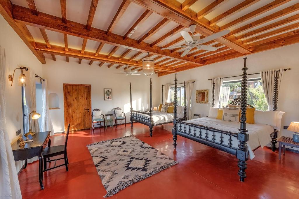 a large living room with a bed and a table at SaffronStays Satori Hornbill, Ultra Luxe two bedroom Villa on 8 Acres Estate, By The Mulshi Lake in Mulshi