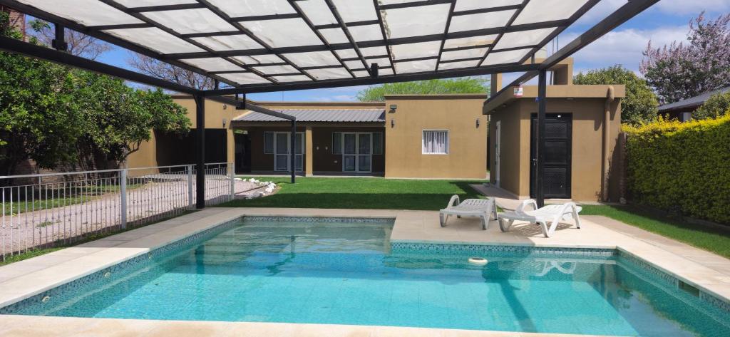 a swimming pool with a pergola and a house at Finca Las Tres Hermanas en La Banda in La Banda