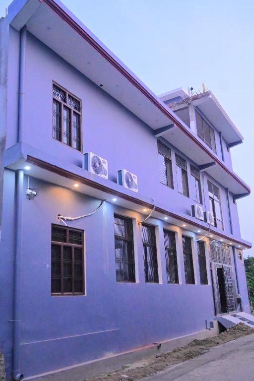 a blue building with lights on the side of it at Shree Ramanam Palace in Ayodhya