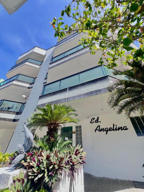a white building with the words el antigua on it at Cantinho na praia in Arraial do Cabo