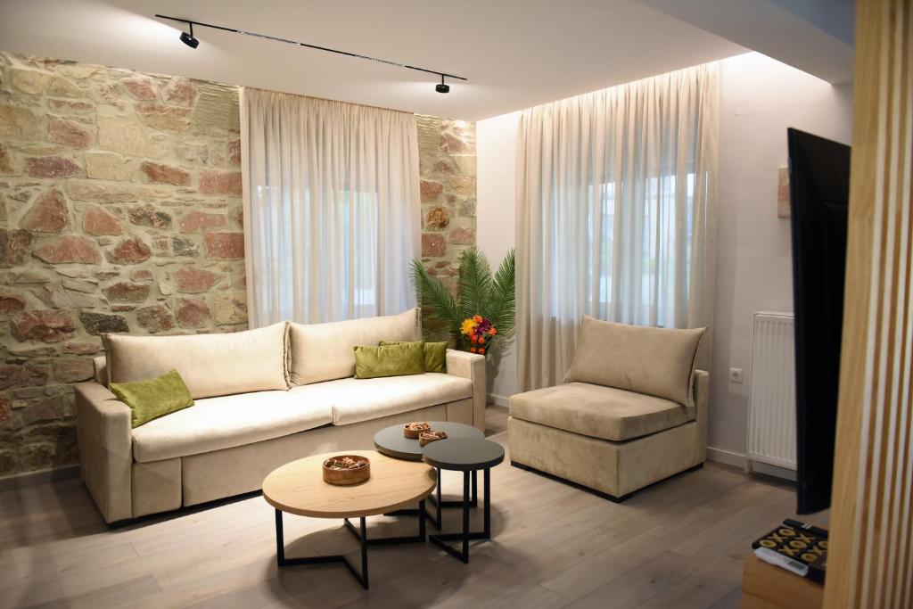 a living room with a couch and a chair at The Cozy Flat 88m2 in Mytilene