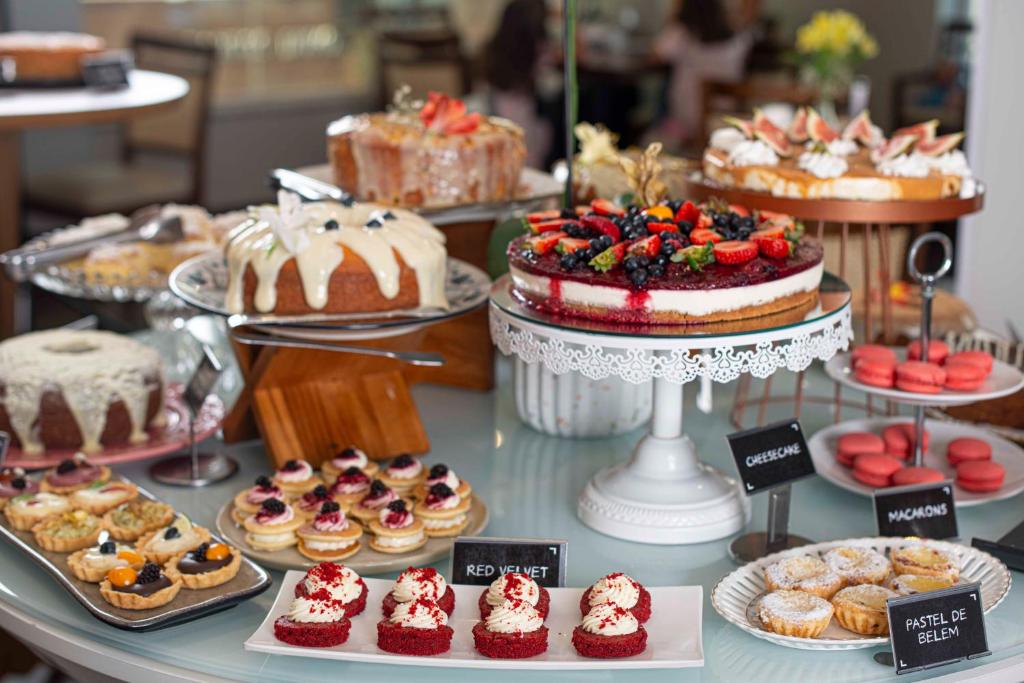 una exposición de pasteles y pastas en una mesa en Santa Inn Hotel, en Balneário Camboriú