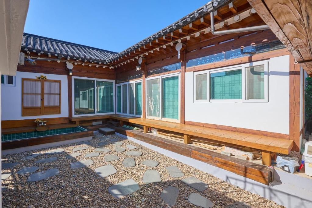a house under construction with a stone patio at Andong Hanok Stay Traditonal House 안동별장 