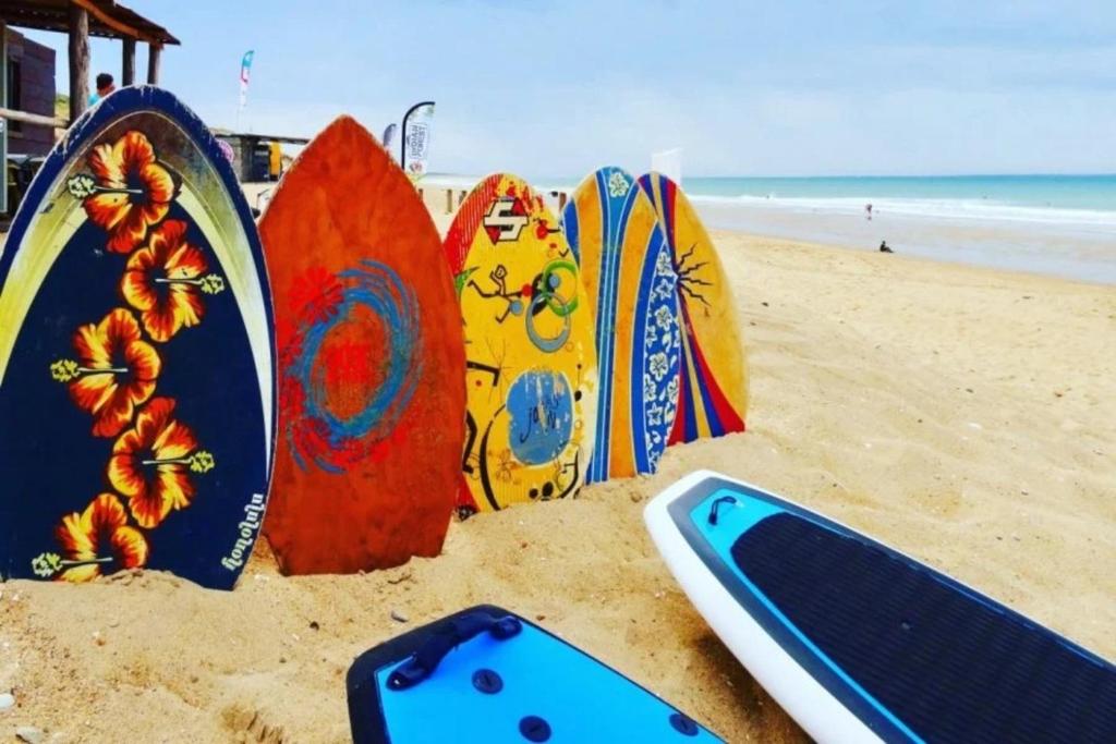 a group of surfboards in the sand on a beach at Villa L'Acacias in Longeville-sur-Mer