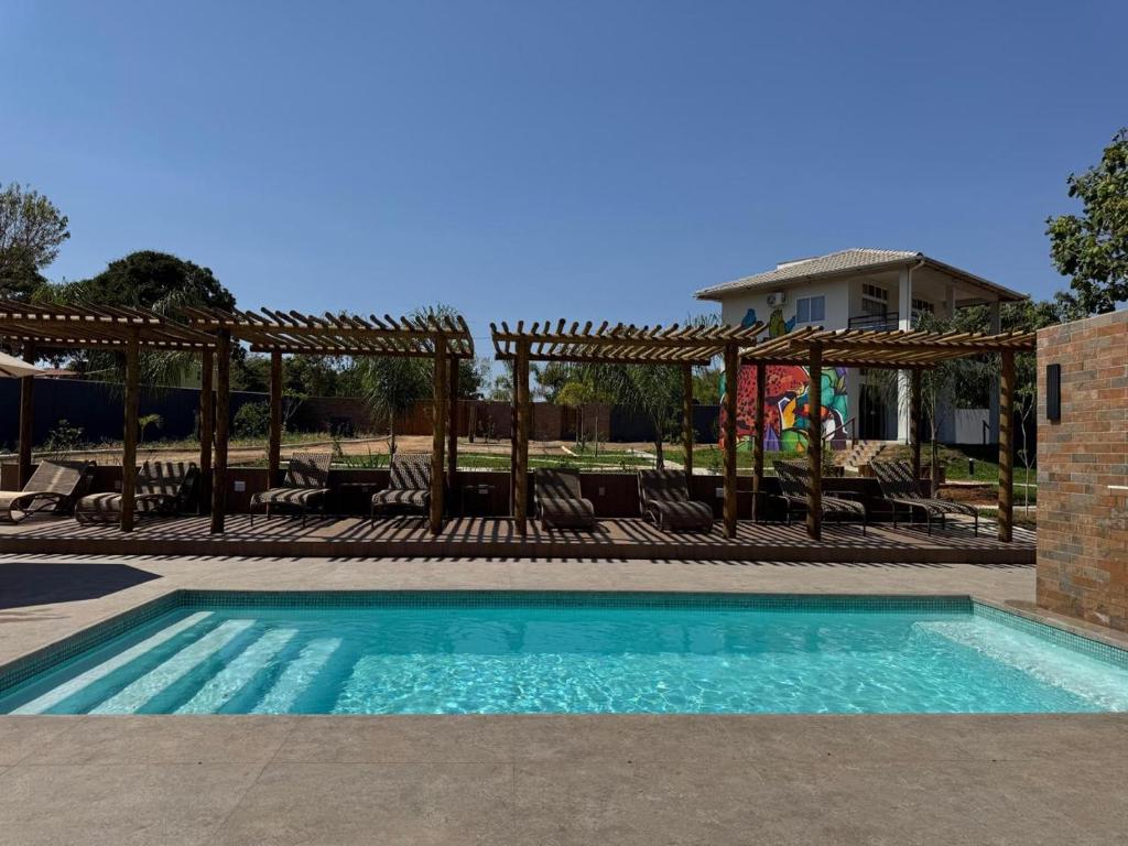 a swimming pool with a gazebo at Chácara Reserva do Cerrado in Cavalcante