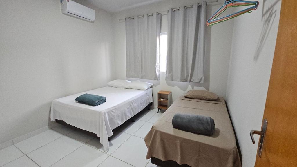 a bedroom with two beds and a kite on the wall at Casa Coqueiro in Primavera do Leste