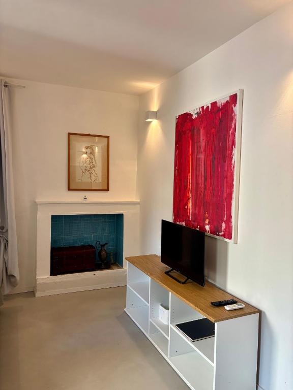 a living room with a tv and a fireplace at Maison62 in San Severino Marche