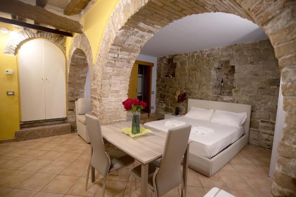 a bedroom with a bed and a table and chairs at Cozy Suite - Special Nest in Perugia in Perugia