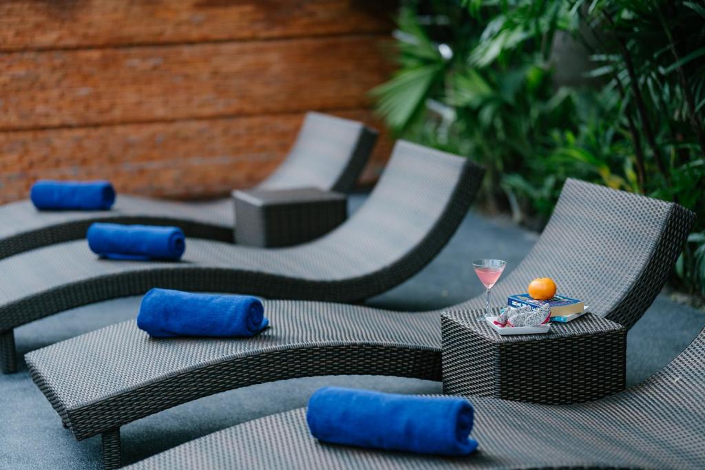 Poolside chaise loungers styled with blue towels and refreshments.
