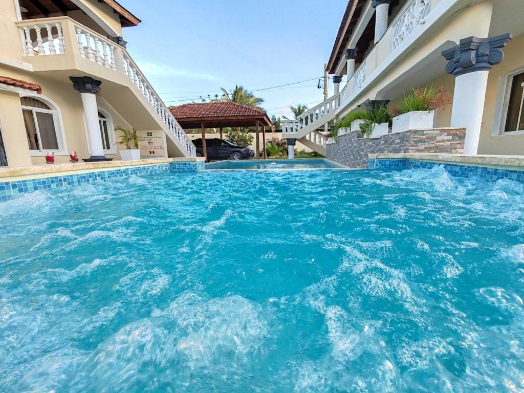 a swimming pool in the middle of a house at Elegant 7BRVilla in Cabarete, Whirlpool, Pool, Beach, Adventure! in Cabarete