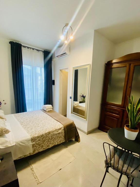 a bedroom with a bed and a table and a window at Da Fernanda in Guidonia