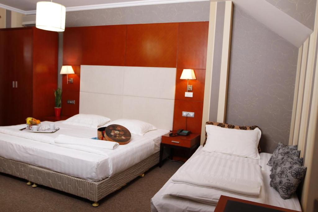 Postel nebo postele na pokoji v ubytování Bel Conti Hotel