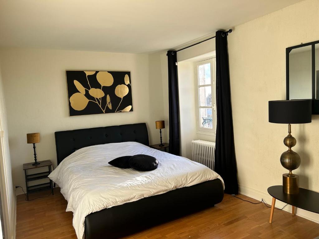 a bedroom with a bed with a hat on it at Logis de Russay in Saivres