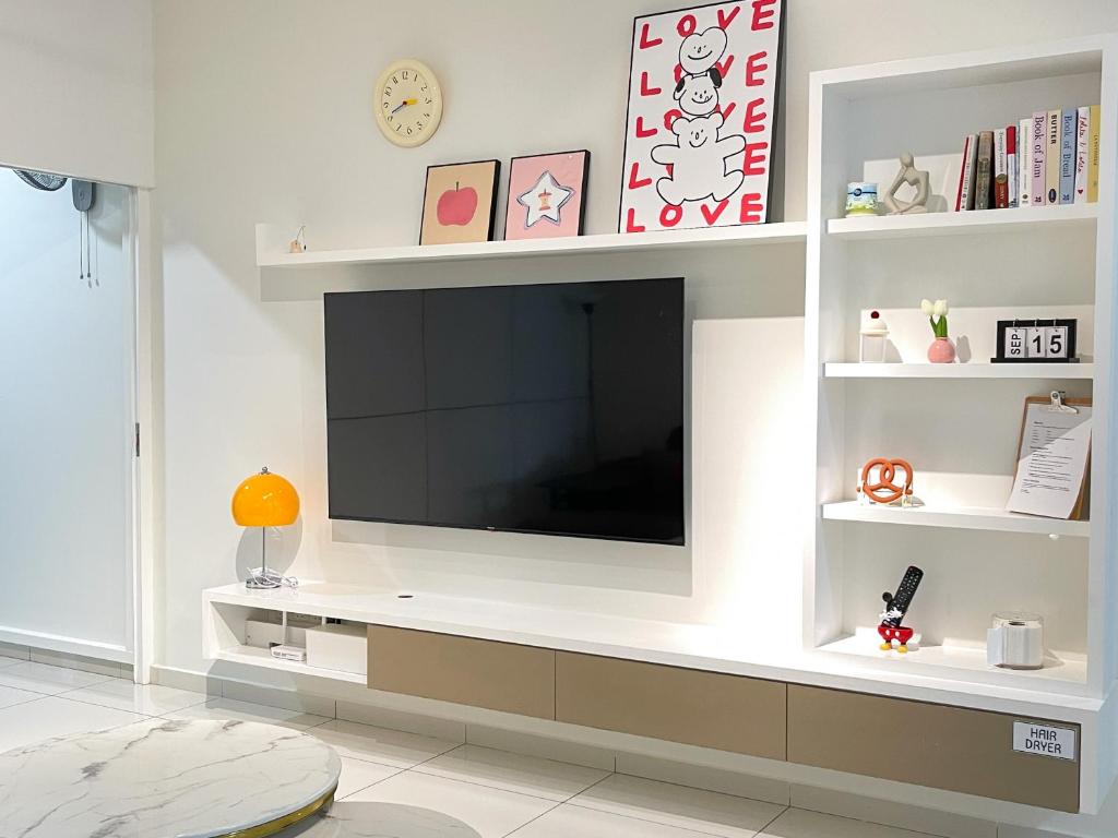 a living room with a flat screen tv on a wall at Beacon Executive Suite with SkyPool 3BR 8pax Georgetown Penang in Georgetown