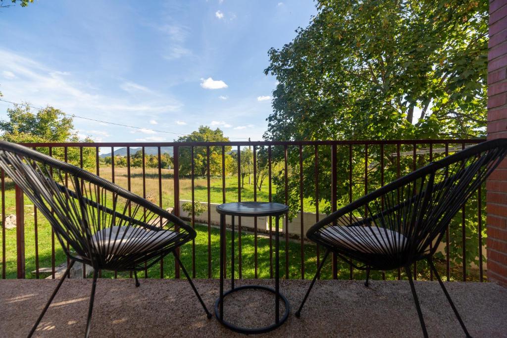 two chairs and a table on a balcony at Lika Bearadise in Štikada