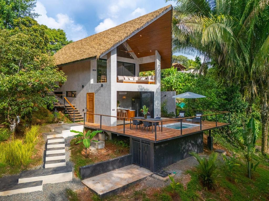 a house with a large deck and a patio at Mandala Ojochal Boutique Resort & Retreat Center in Ojochal