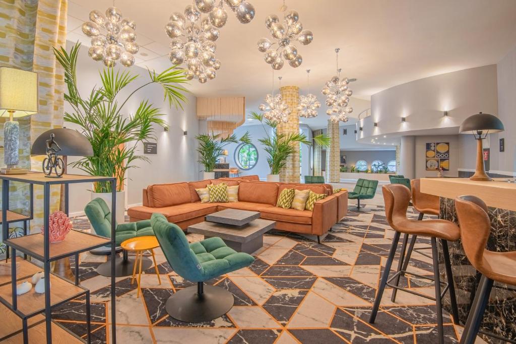 a living room with a couch and chairs at Castrum Hotel Székesfehérvár in Székesfehérvár