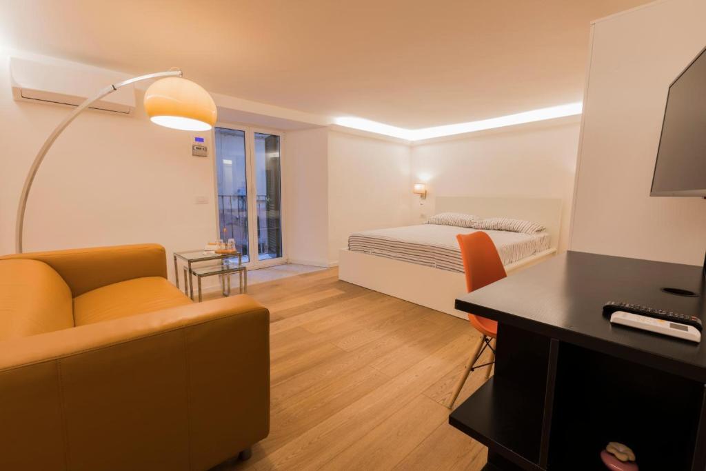 a living room with a bed and a couch at Casa Fabrizio Ai Gradoni Di Chiaia in Naples