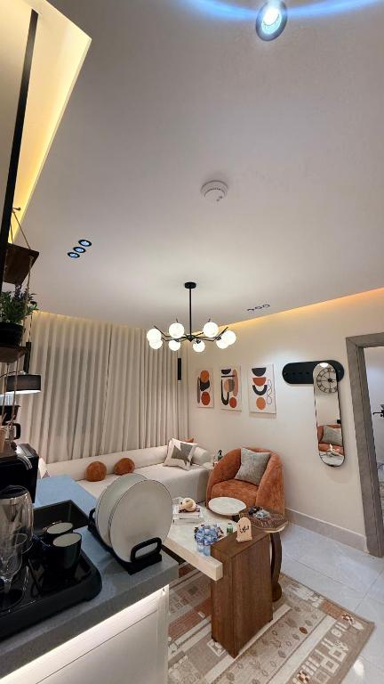 a living room with a couch and a table at سكاي لاين سويت in Jeddah