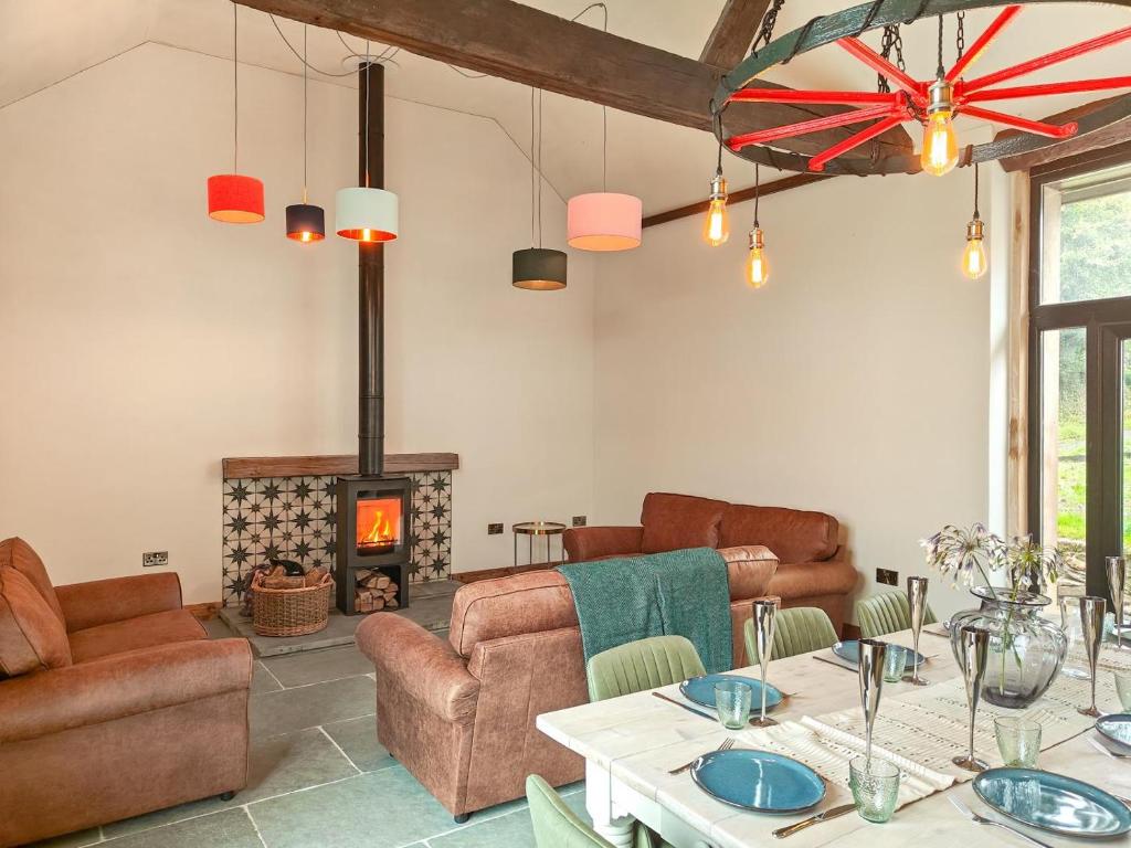 a living room with a table and a fireplace at 3 Bed in Dulverton oc-t32975 in Dulverton