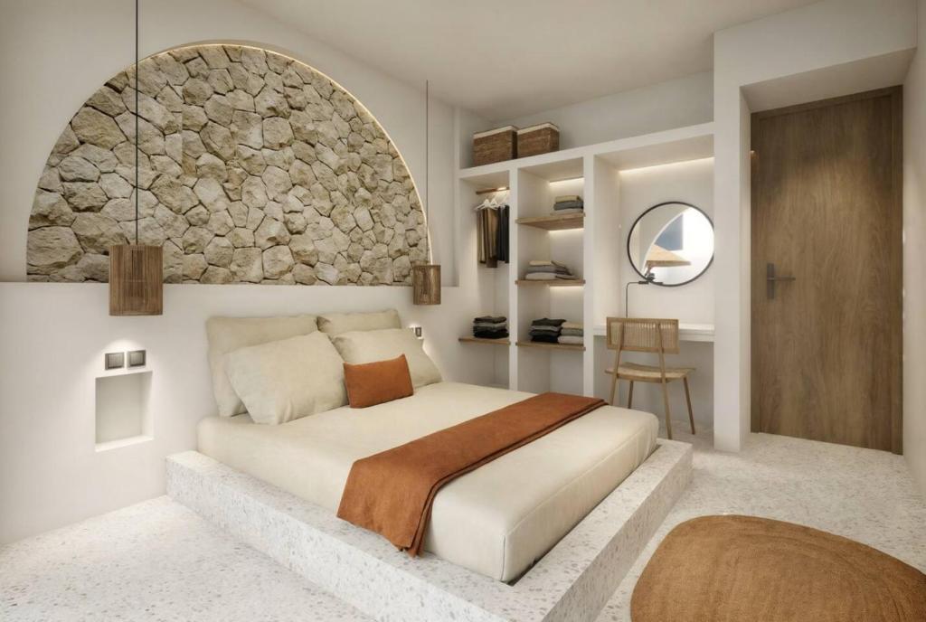 a bedroom with a bed and a stone wall at Modern 3BR Villa, Rooftop Dining and Fast WiFi in Pererenan