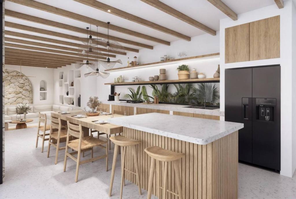 a kitchen with a large island with stools at Stylish 3BR Villa - Walk to Pererenan Beach in Pererenan