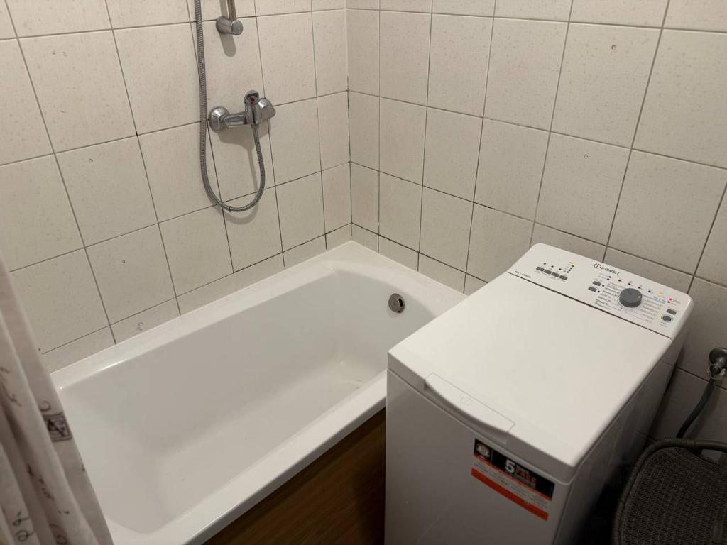 a white bath tub in a bathroom with a shower at Zolhome in Warsaw
