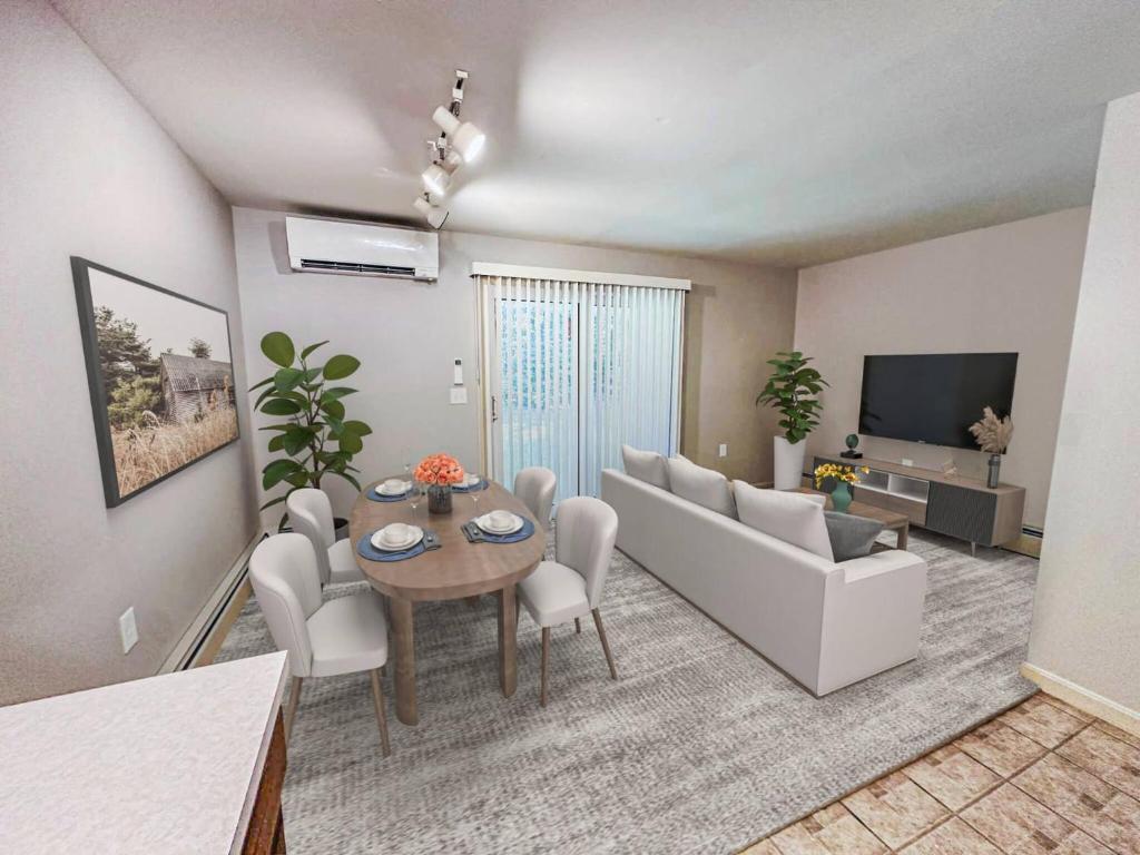 a living room with a table and a couch at NEW-Queen Bed-Yard Space-Quiet Neighborhood-NH- in Hudson