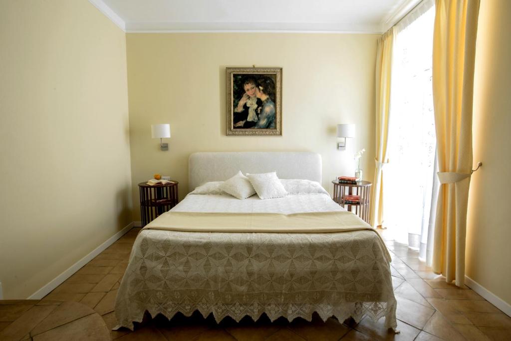 a bedroom with a bed and a large window at Donna Chiara in Nusco